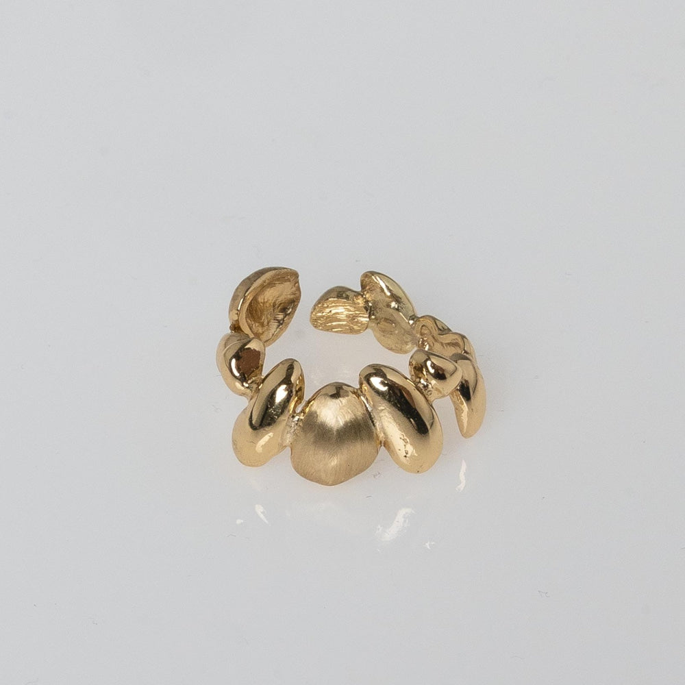 Close-up product shot of handmade adjustable brass ring with organic sculptural pebble design — Tame Ring by Kalliope Jewelry, crafted in Greece