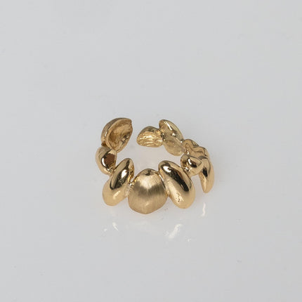 Close-up product shot of handmade adjustable brass ring with organic sculptural pebble design — Tame Ring by Kalliope Jewelry, crafted in Greece