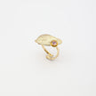 Limpet Ring — handmade brass adjustable ring with textured shell disc and gemstone detail on white background