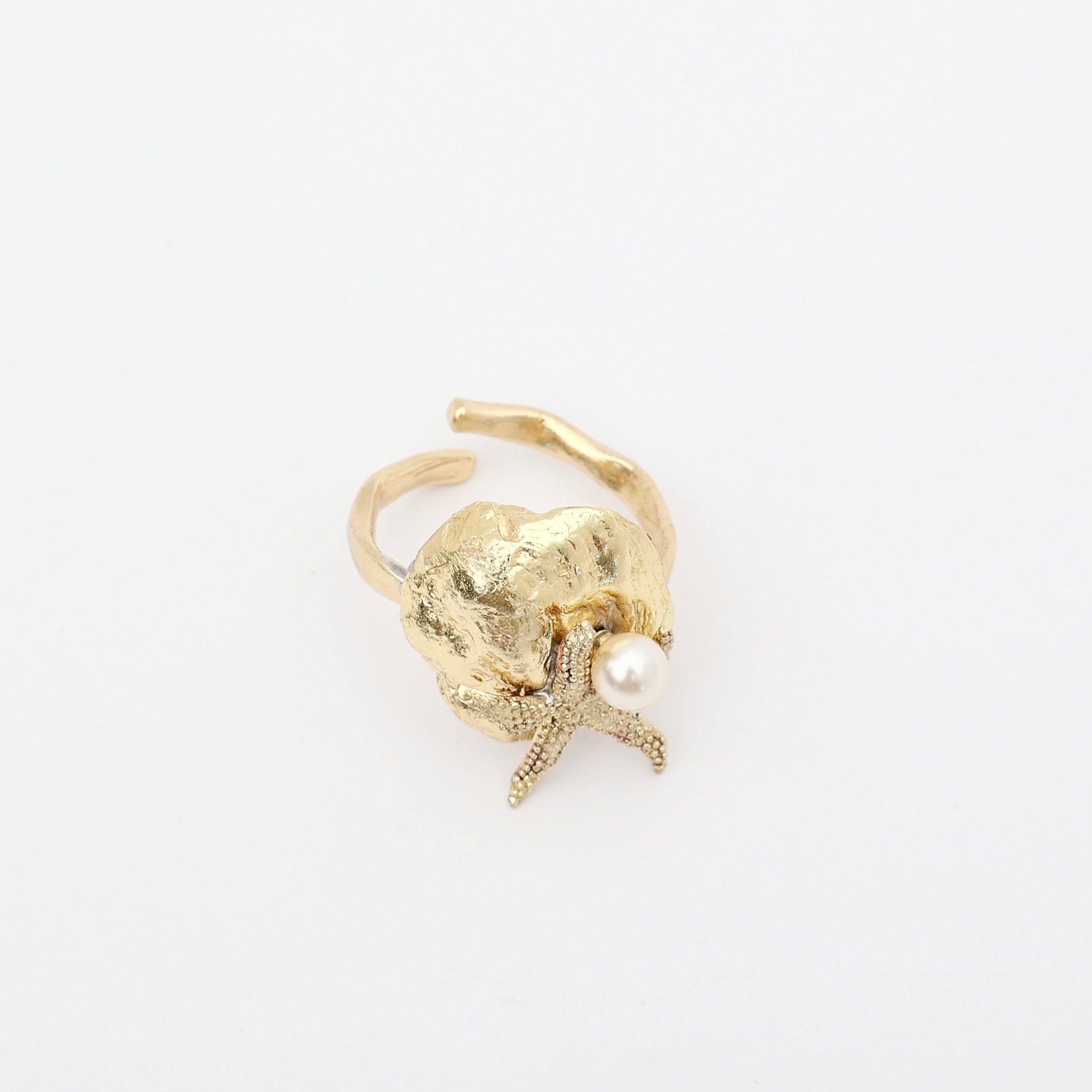 Tide Ring — handmade brass adjustable ring with sculptural shell and pearl on white background