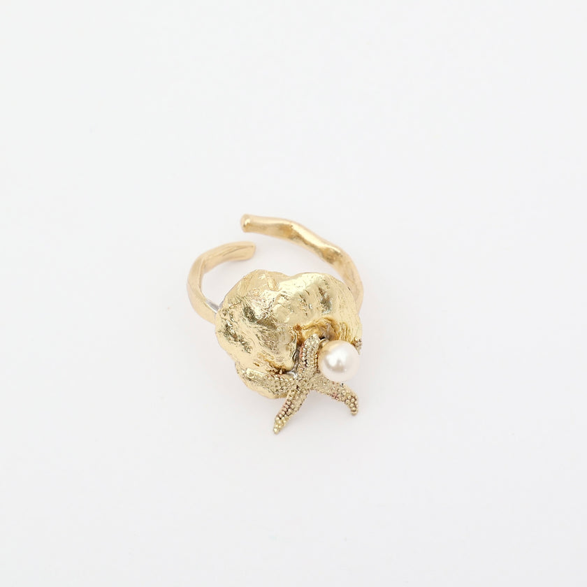 Tide Ring — handmade brass adjustable ring with sculptural shell and pearl on white background