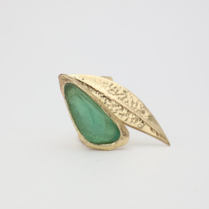 Handmade brass bold cocktail ring with raw resin stone set in textured leaf motif
