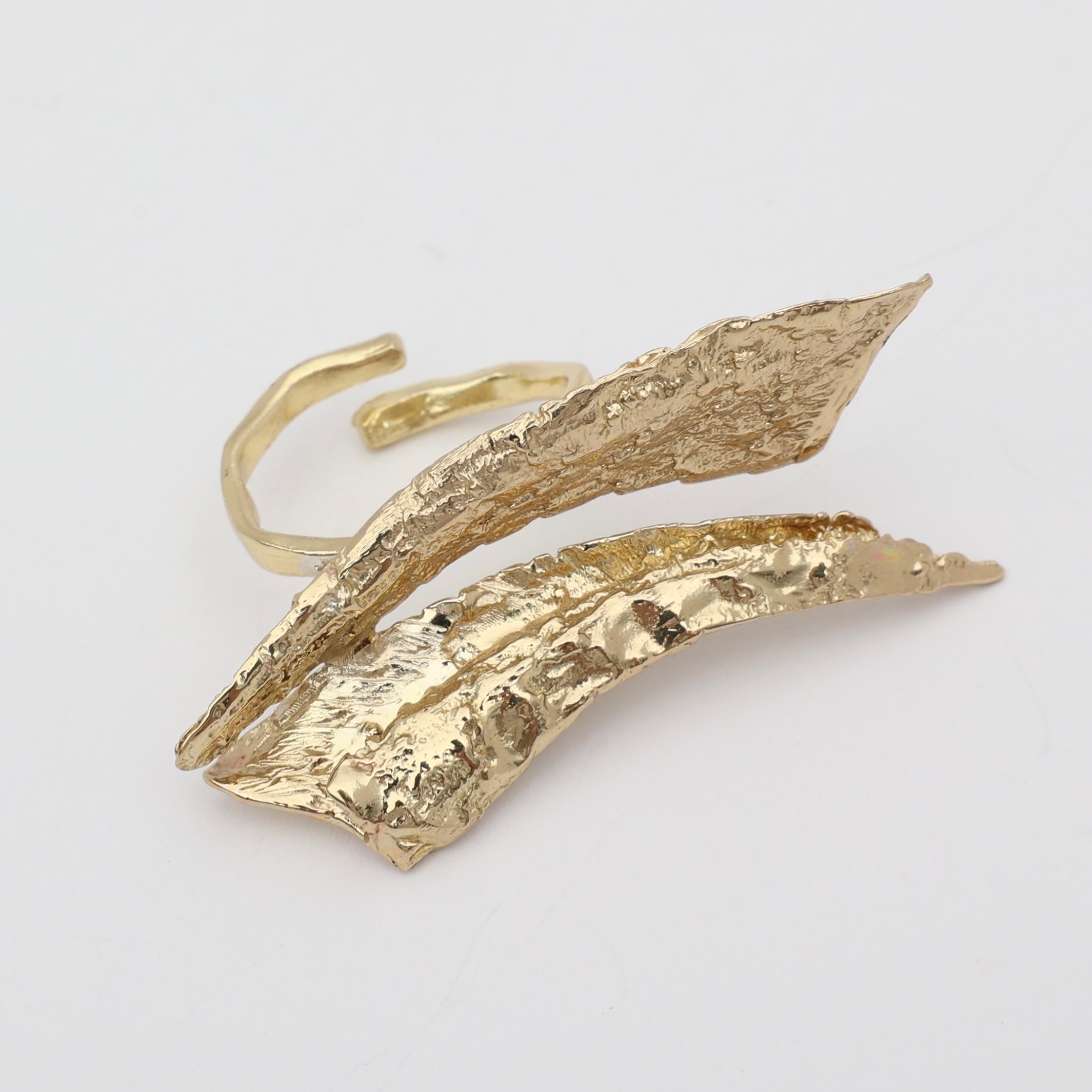 Nerra Ring top view — handmade brass sculptural ring with overlapping textured blades