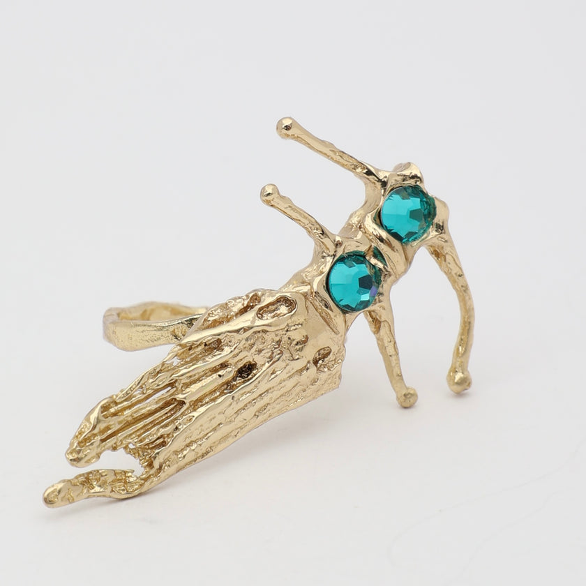 Draco Ring close-up — handmade brass artisan ring with textured fish body and prong-set crystal stones