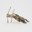 handmade brass artisan ring with textured fish body and prong-set crystal stones on white background