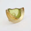 Pond Ring side view — handmade brass architectural ring with smooth curved shield and freeform resin stone
