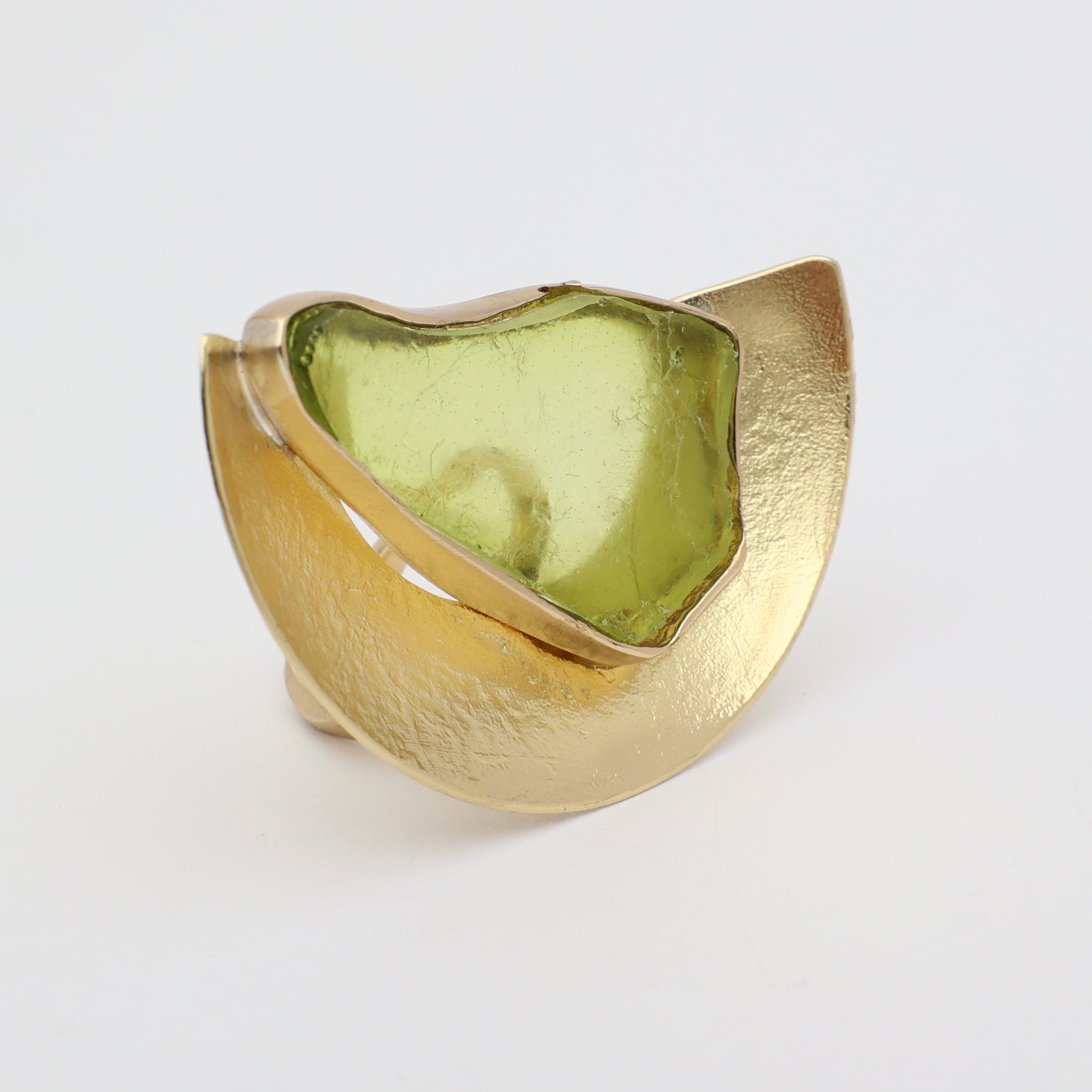 Pond Ring side view — handmade brass architectural ring with smooth curved shield and freeform resin stone
