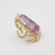 Crabby Ring angle view — handmade brass cocktail ring with full crab silhouette and smooth stone centerpiece