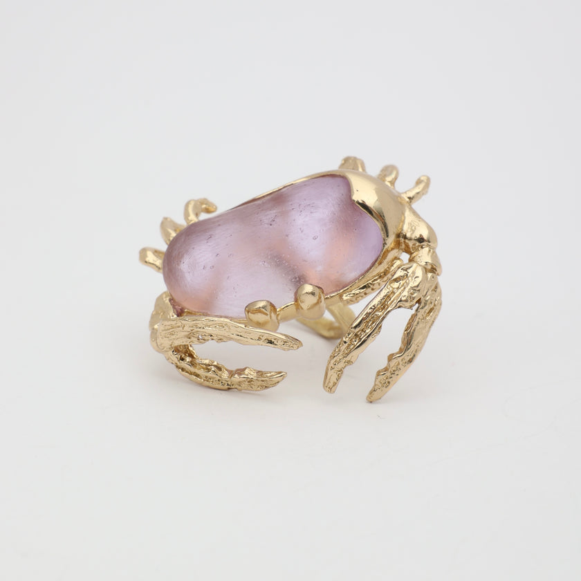 Crabby Ring close-up — handmade brass ring with detailed crab claw prongs gripping oversized resin stone
