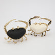 Claw Crabby Ring flat lay — handmade brass sculptural crab ring with wide resin stone centerpiece and crystal accents