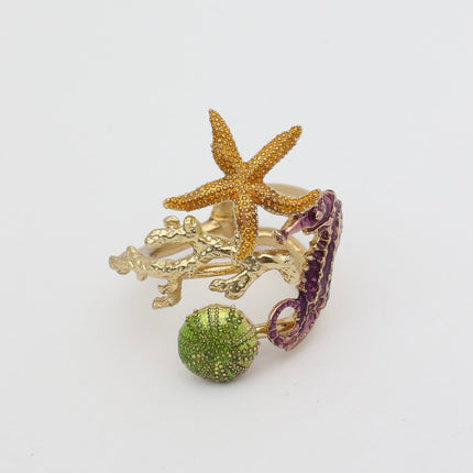 Coralia Ring — handmade brass statement ring with starfish, seahorse, coral and sea urchin on white background