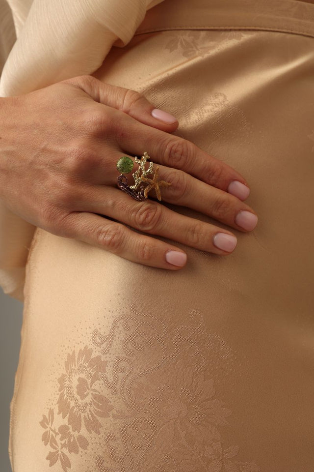 Coralia Ring on model — handmade brass statement ring worn on finger showing scale of sculptural underwater scene