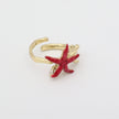 Astel Ring — handmade brass statement ring with starfish and coral sculpture and crystal stone on white background
