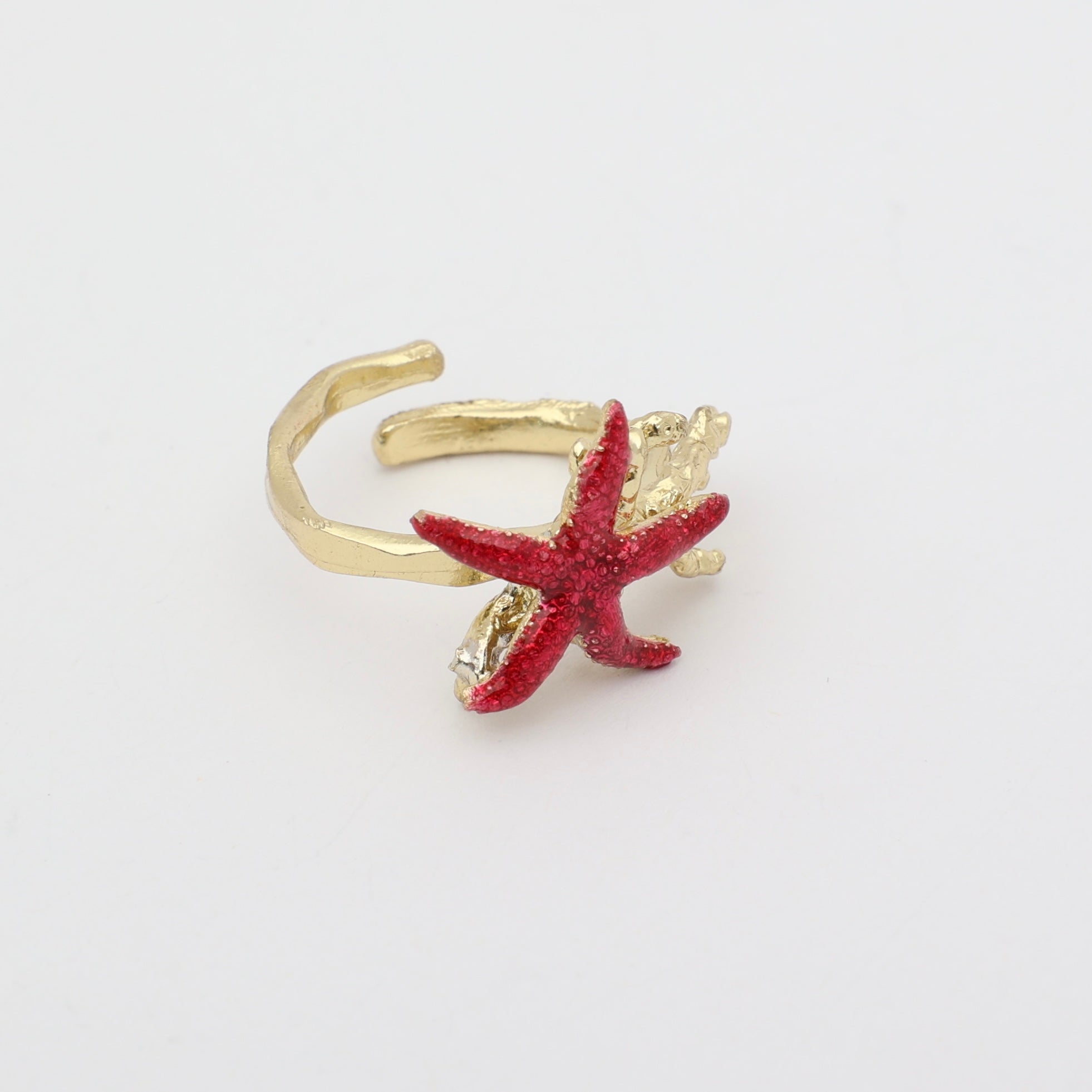 Astel Ring — handmade brass statement ring with starfish and coral sculpture and crystal stone on white background
