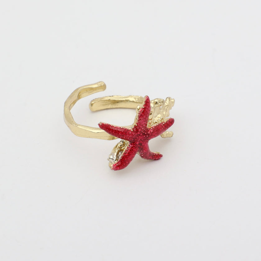 Astel Ring — handmade brass statement ring with starfish and coral sculpture and crystal stone on white background
