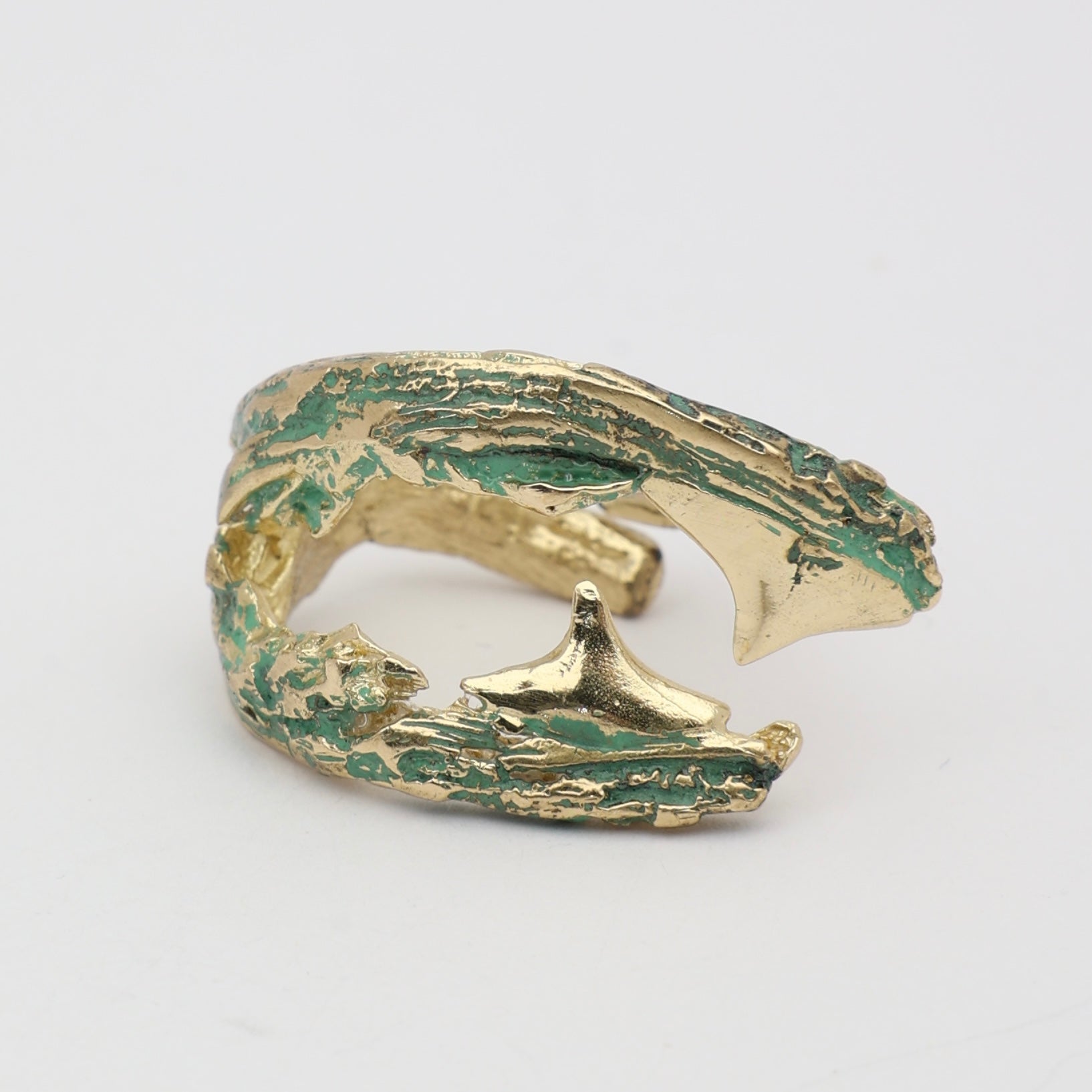 Claw Ring — handmade brass statement ring with wide wraparound textured body and verdigris detail on white background