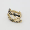 Claw Ring side view — handmade brass ring with deeply grooved barnacle-texture surface and tapered open ends