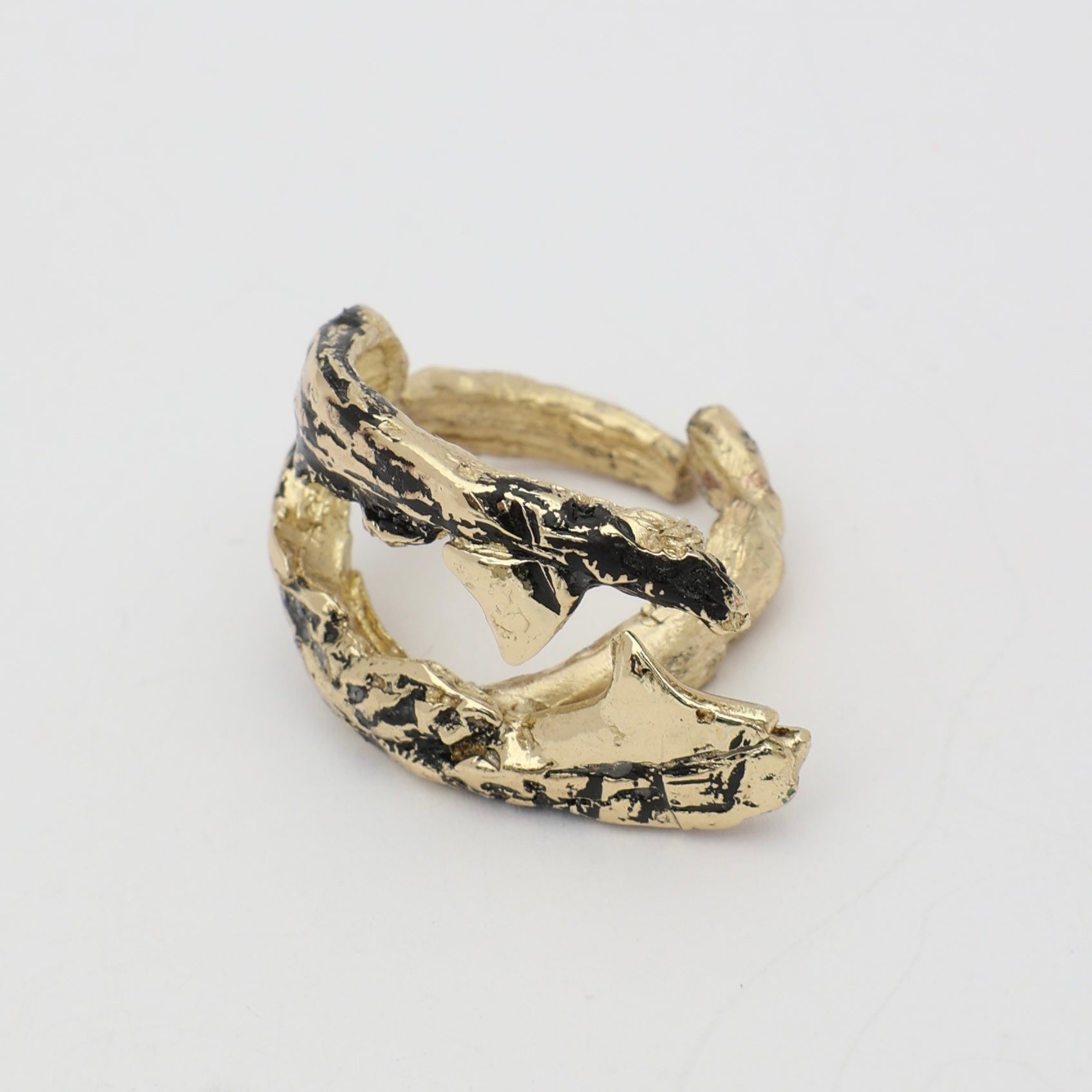 Claw Ring side view — handmade brass ring with deeply grooved barnacle-texture surface and tapered open ends