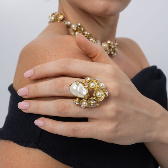 Handmade brass pearl cluster ring worn on hand with matching necklace
