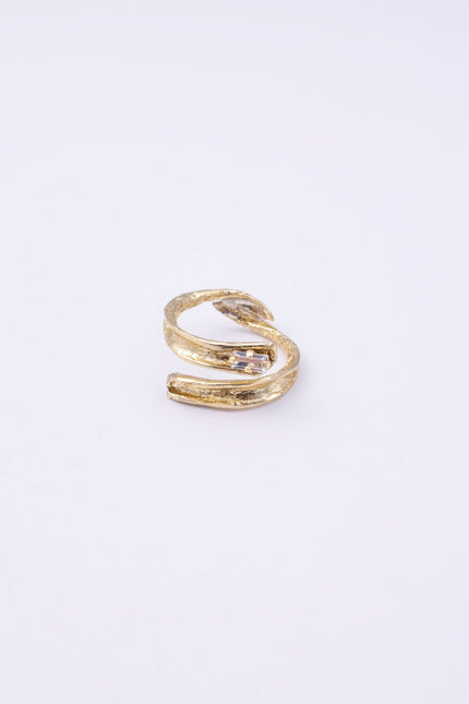  Glade handmade gold-plated brass wrap ring with organic texture and clear baguette-cut crystal on a white background