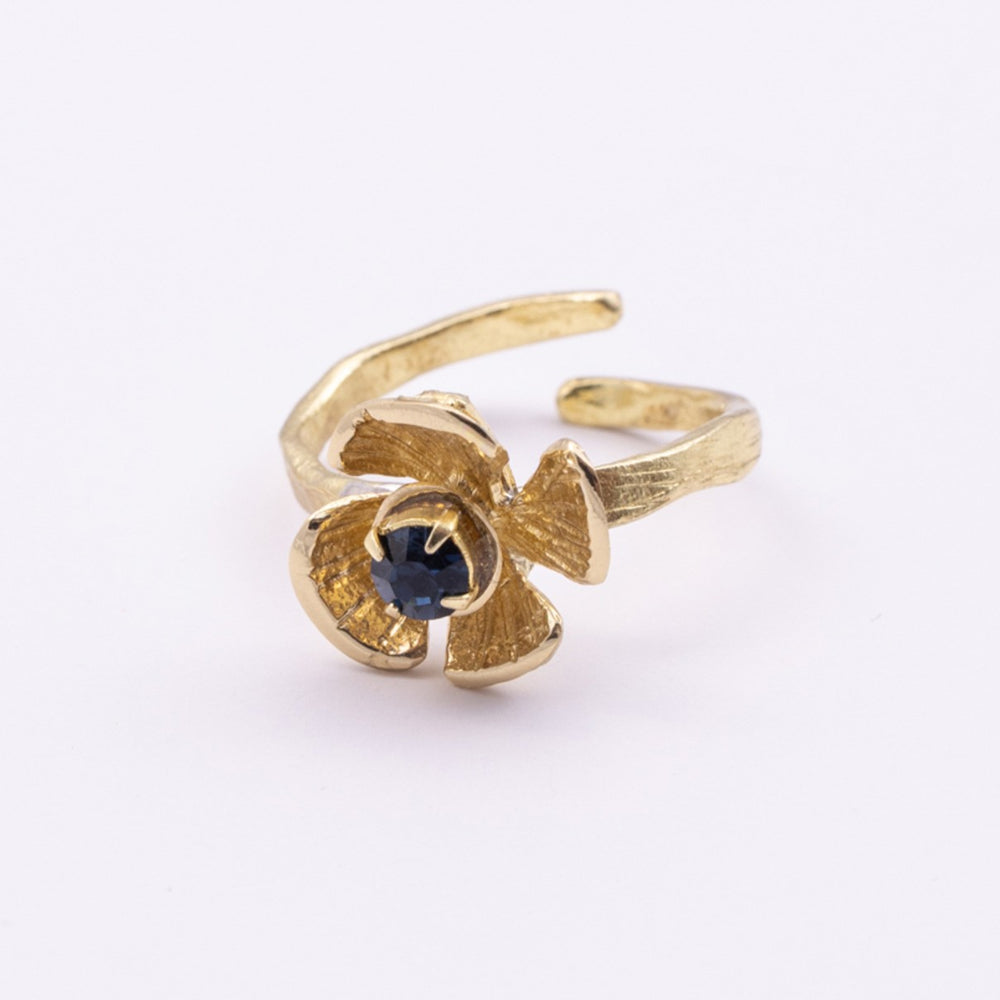 Posy Ring close-up — handmade brass ring with faceted crystal stone set into layered petal center