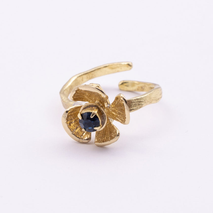 Posy Ring close-up — handmade brass ring with faceted crystal stone set into layered petal center