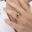 Posy Ring flat lay — handmade brass flower ring with faceted crystal stone and textured petal edges