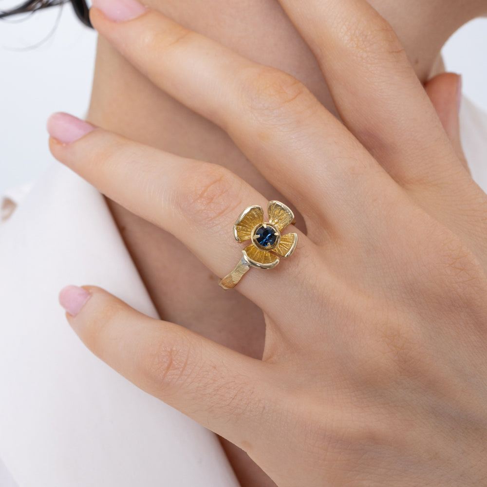 Posy Ring flat lay — handmade brass flower ring with faceted crystal stone and textured petal edges