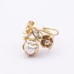 Bouquet Ring — handmade brass floral statement ring with crystal stones and pearl on white background