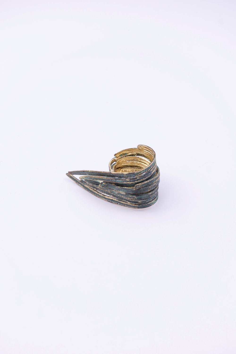 Pine handmade gold-plated brass ring with green patina and gold details, side view on white background