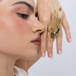 Model wearing the Peacock gold-plated statement ring with black oxidized bird and pink, mint and smoky teardrop crystals, Savage Flora
