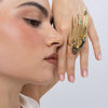 Model wearing the Peacock gold-plated statement ring with black oxidized bird and pink, mint and smoky teardrop crystals, Savage Flora