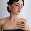 Handmade asymmetric crystal ring and geometric gold earrings worn with a black strapless dress, Glitter Kiss