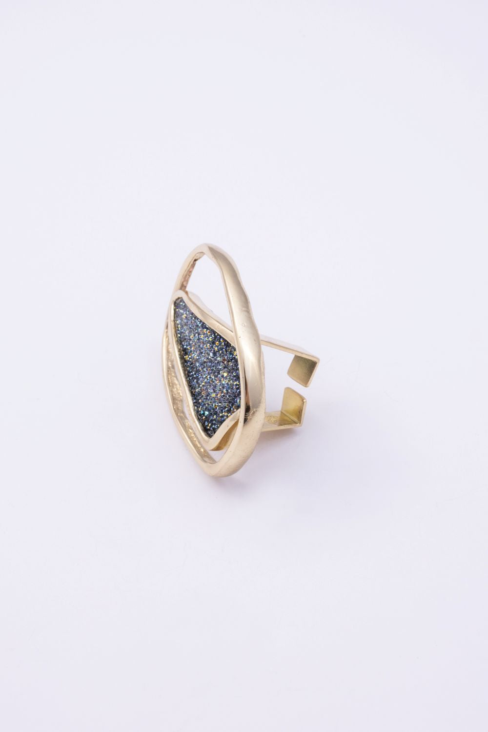 Side view of handmade gold crystal ring showing open adjustable-style back