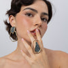 Model wearing Glitter Kiss open frame crystal ring with matching geometric crystal earrings