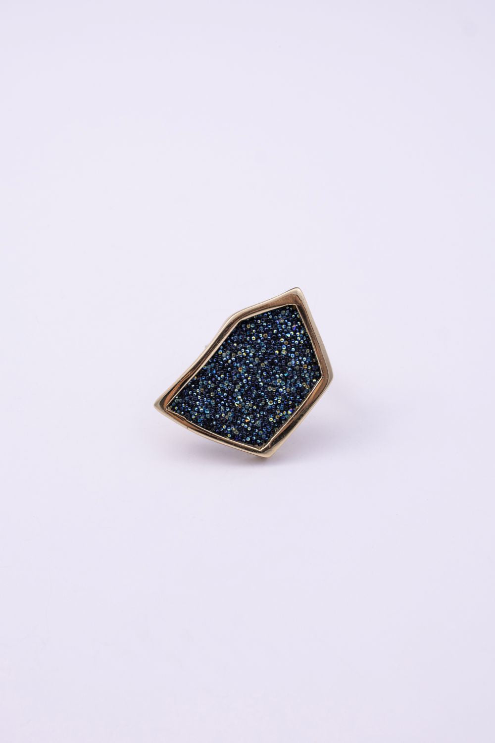 Front view of handmade gold geometric ring with compressed crystal surface