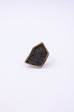 Top view of angular gold crystal ring with textured crystal panel