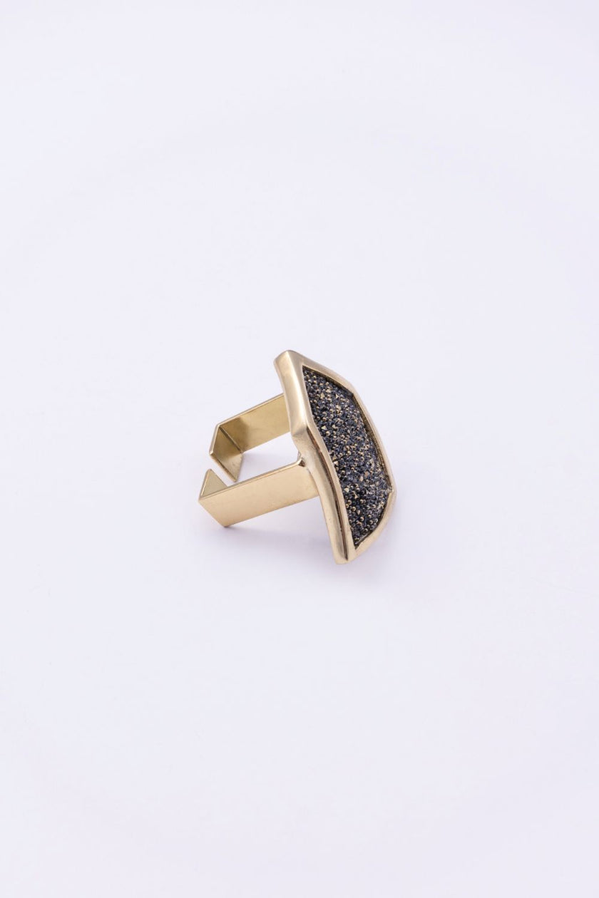 Angled view of sculptural geometric crystal ring with open back