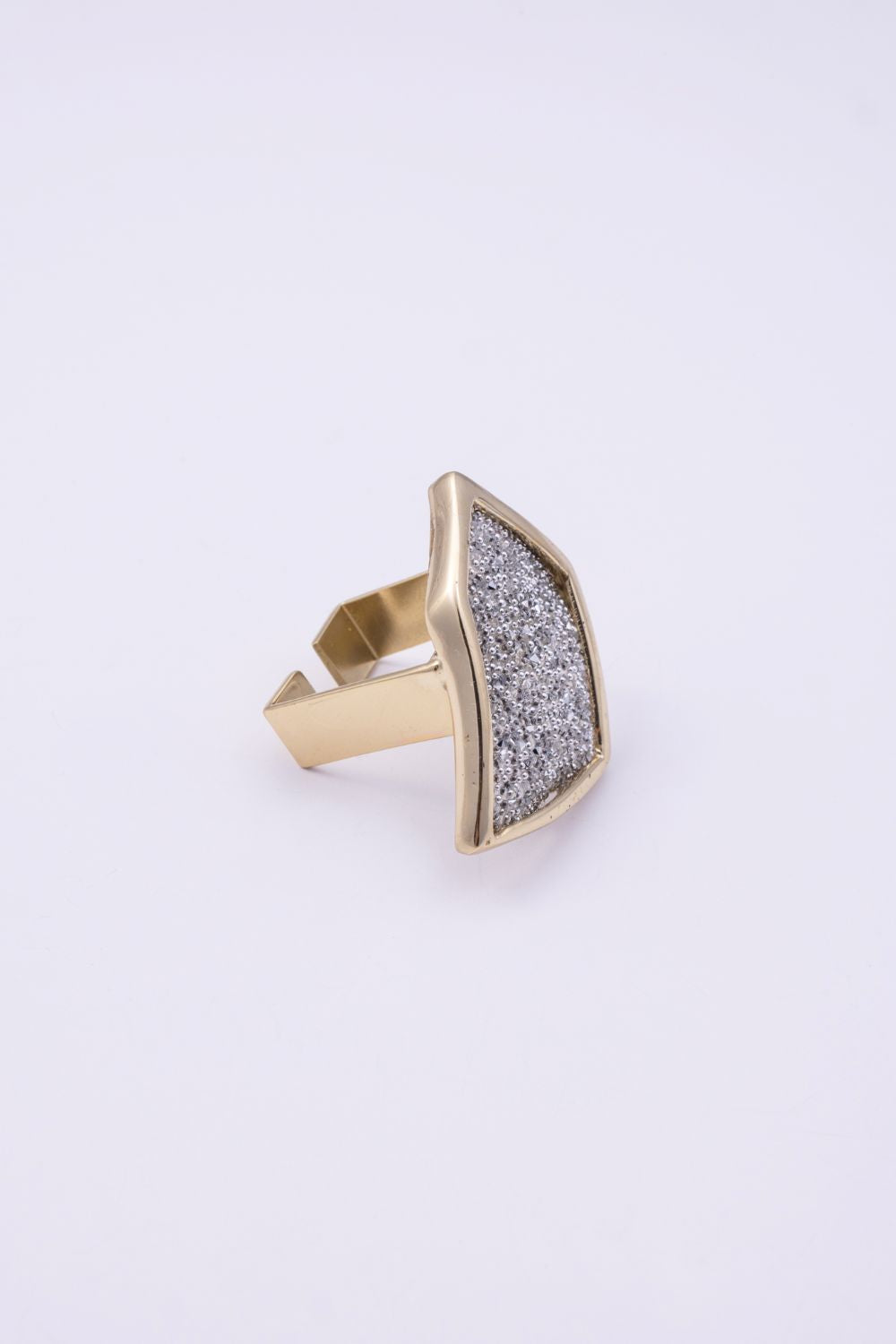 Gold geometric statement ring with crystal panel and open band, side view