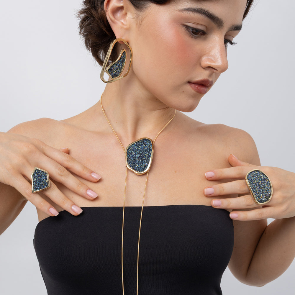 Shimmer Long Necklace on model, close up: handmade brass statement necklace with oval crystal pendant