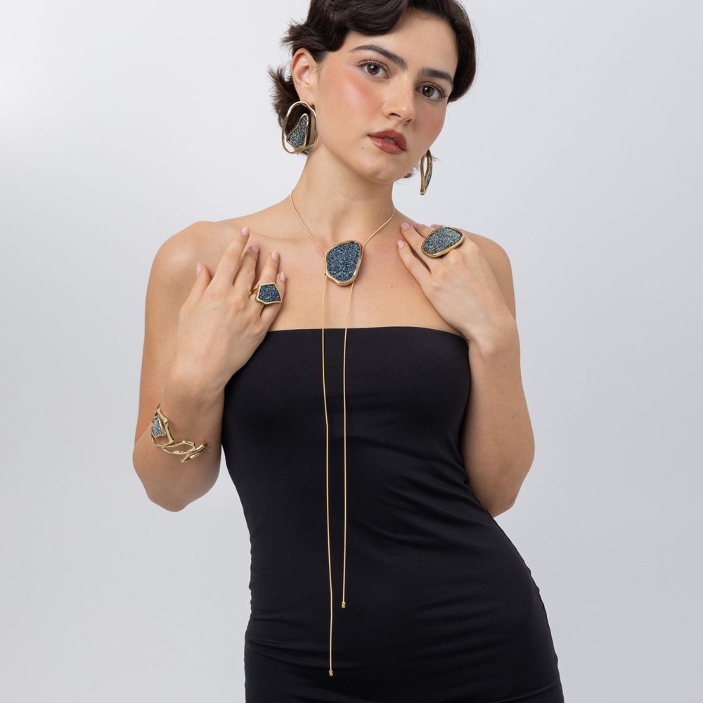 Model wearing Glitter Kiss geometric crystal ring with matching crystal earrings, necklace and cuff bracelet