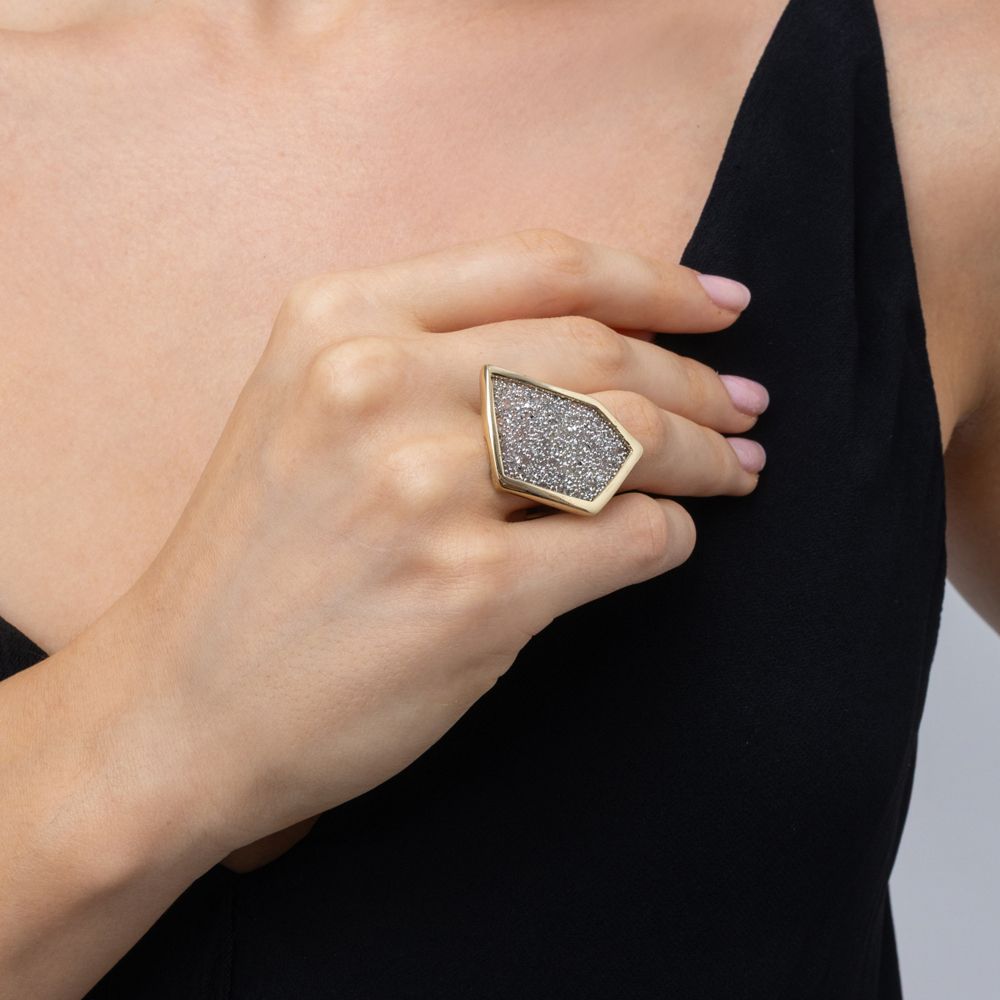 Hand wearing geometric crystal statement ring with black V-neck dress, Glitter Kiss collection