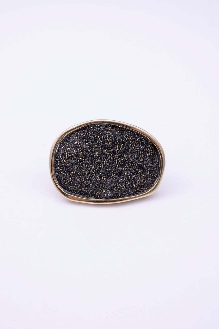 Top view of large oval crystal ring with compressed crystal surface