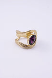 Shiny Boteh handmade gold-plated brass paisley ring with hammered texture and purple crystal on a white background