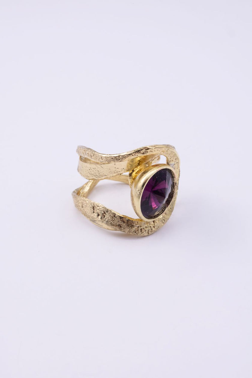 Shiny Boteh handmade gold-plated brass paisley ring with hammered texture and purple crystal on a white background