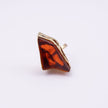 Kite handmade gold-plated statement ring with a large amber raw-cut stone in a sculptural gold setting on a white background