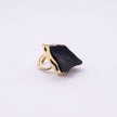 Kite handmade gold-plated cocktail ring with black raw-cut stone and open branch-style band on a white background