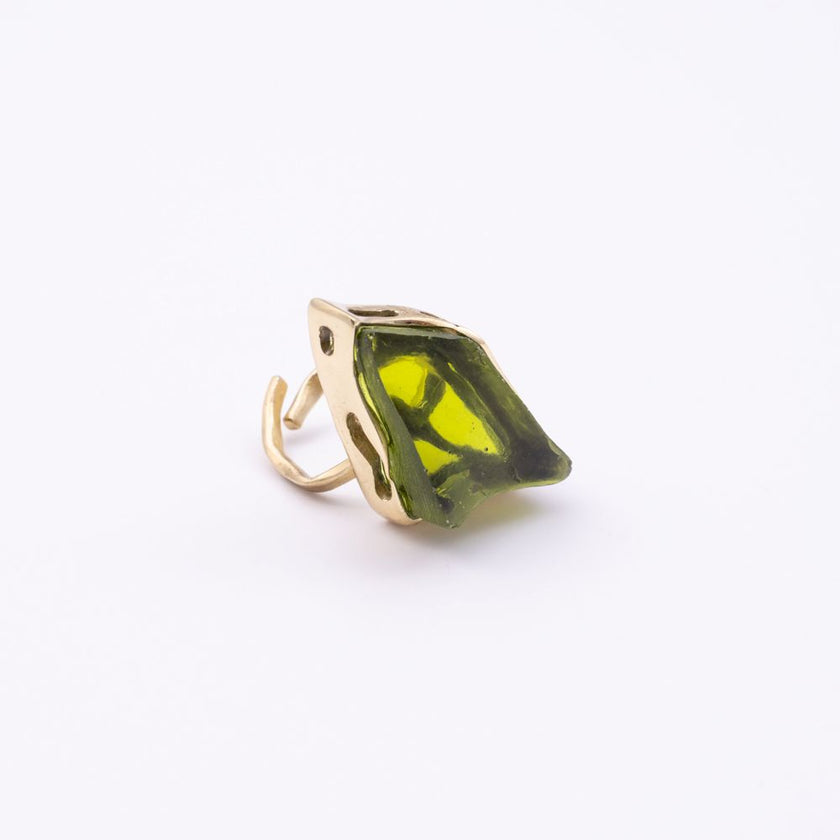 Kite handmade gold-plated cocktail ring with an olive green raw-cut stone and open adjustable band on a white background