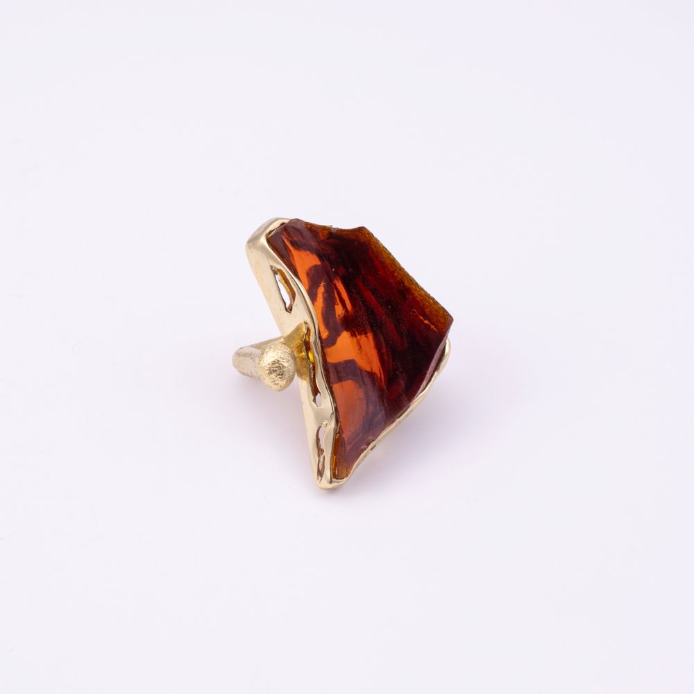 Kate handmade gold-plated statement ring with a large amber resin stone and open band with textured gold ball, side view on white background