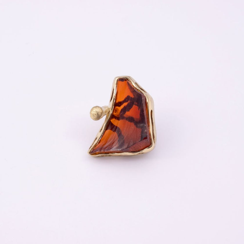 Kate gold-plated brass cocktail ring with amber resin stone in a sculptural gold frame, front view on white background